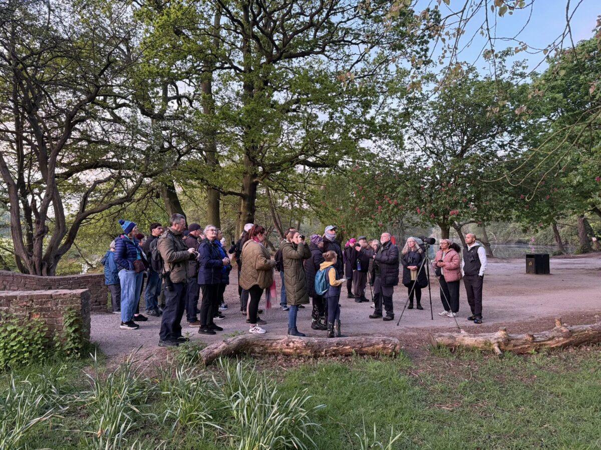 Goup of FoWP members by the lake looking at birds